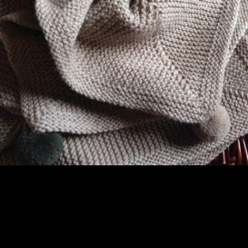 Blanket with pom poms