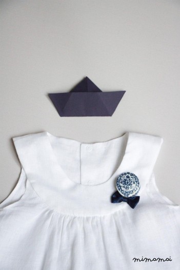 White linen baby dress with Bella brooch