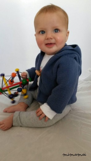 Knitted baby cardigan with pixie hood, knitted in airforce blue